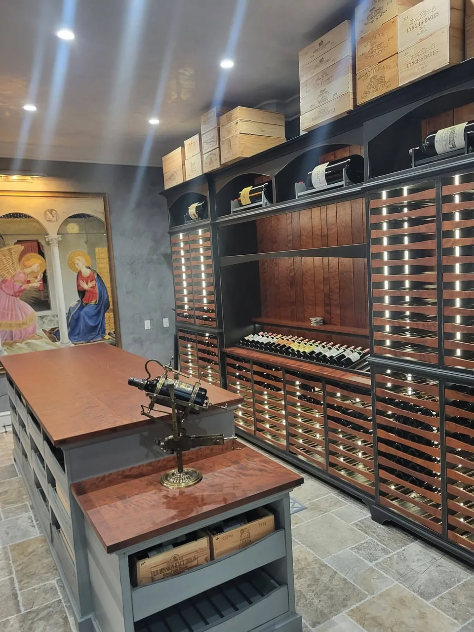 Floor-to-ceiling backlit wine racking with arched display niches.